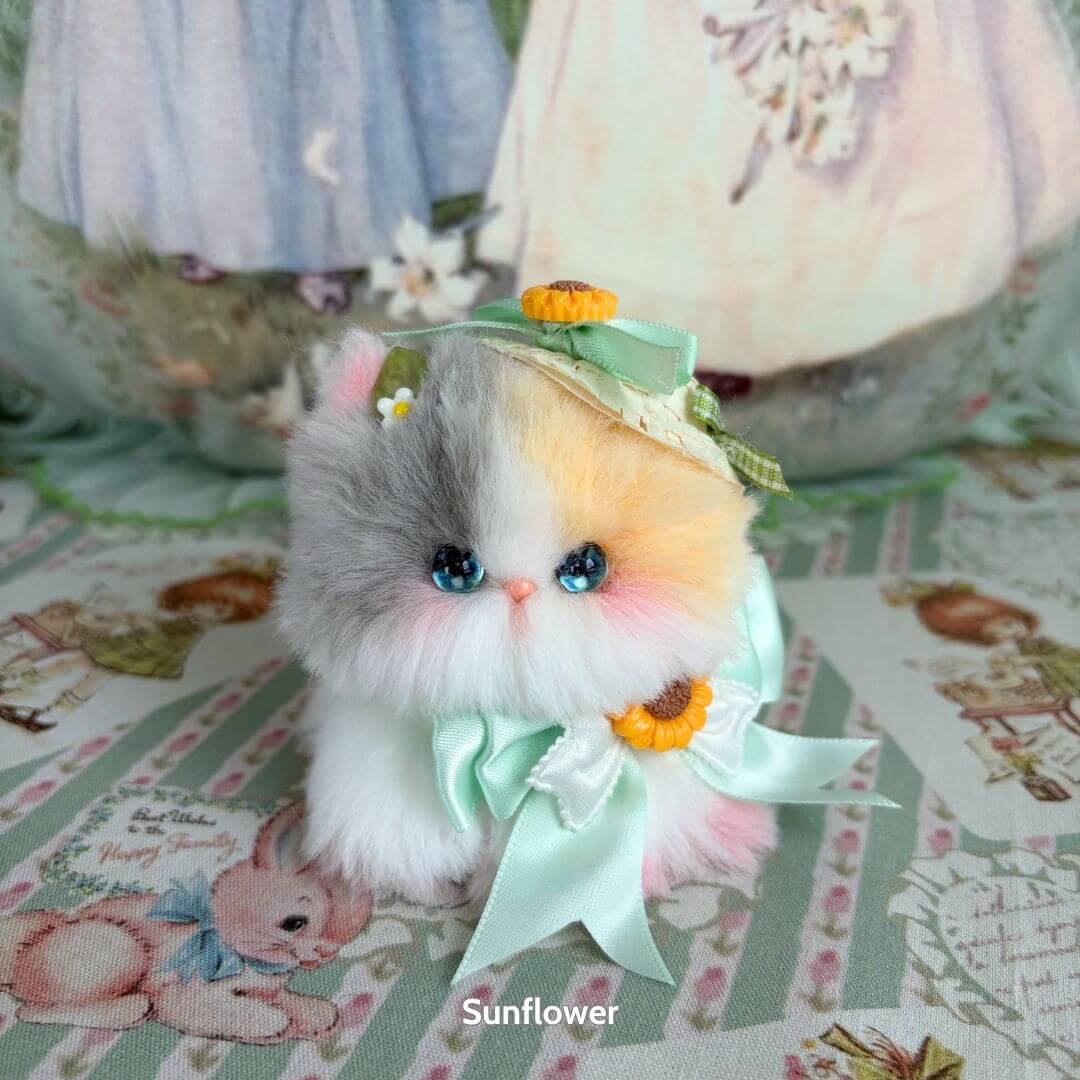 Alt Tag: Blossom Kitten Collection - Handmade kitten with soft grey, white, and orange fur, adorned with a mint bow and floral accents.