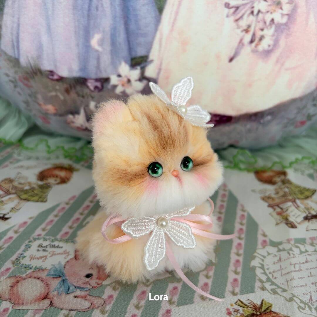 Adorable handmade kitten from Fairy Paws Collection, fluffy orange and cream fur, with pearl collar and delicate wings.