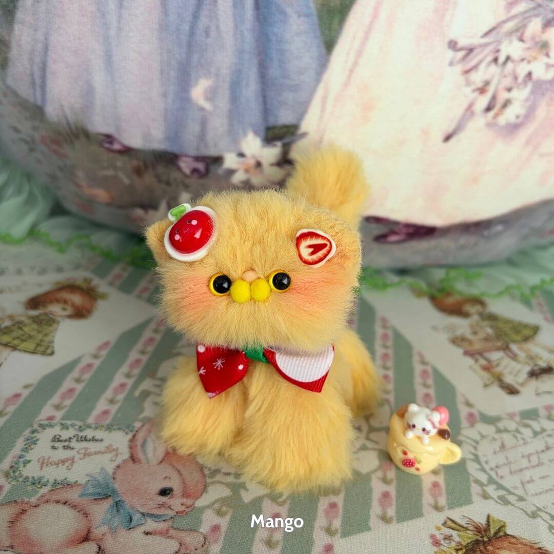 Handmade kitten from the Fruity Kitten Collection, fluffy yellow with strawberry accessories, cute kawaii style, miniature cat.