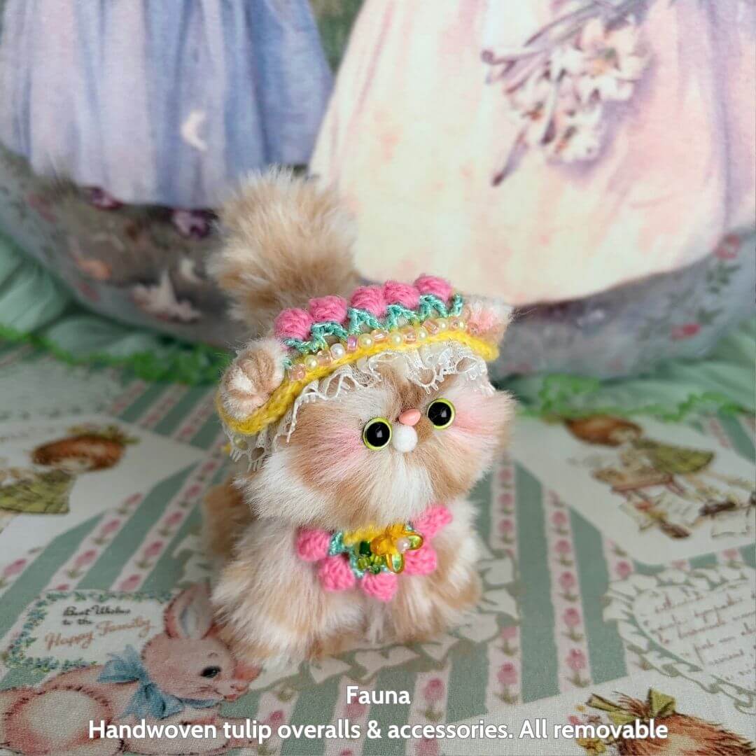 Cute handmade kitten from the Spring Love Limited Collection, featuring fluffy fur, colorful tulip overalls, and playful accessories.