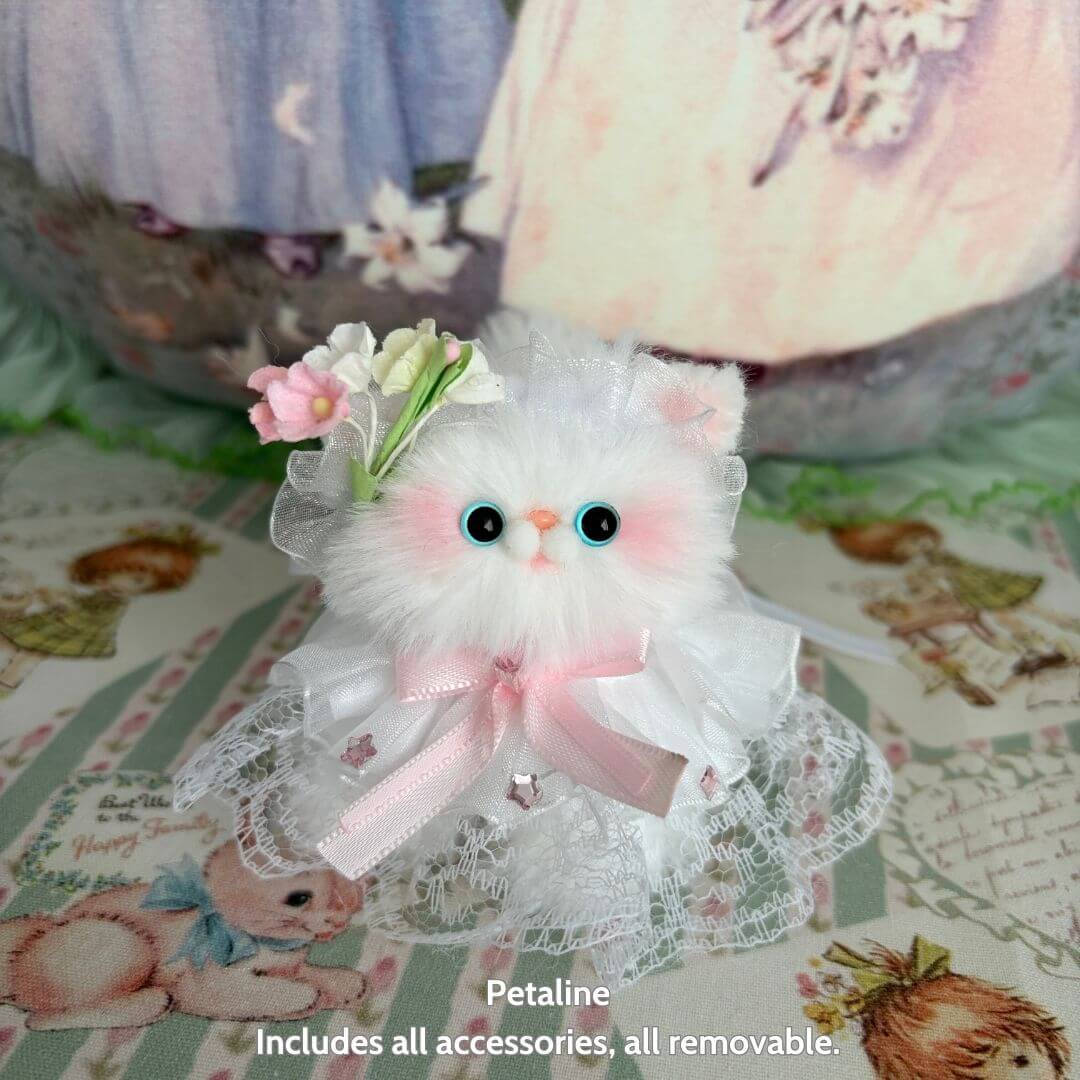 Handmade kitten from Petals & Whispers Collection, fluffy white figurine with pink accents, delicate floral and lace details.