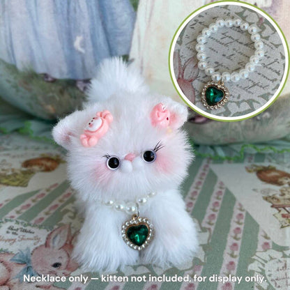 Elegant Heart Necklace on a fluffy white kawaii cat figurine with pink accents, displaying its heart-shaped pendant.