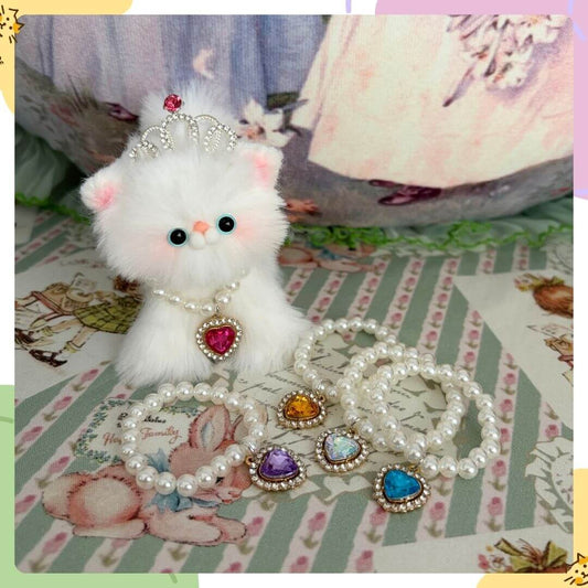 Elegant Heart Necklace with pearl beads and colorful heart pendants, styled on a cute fluffy kitten figurine, perfect for miniature cat decor.