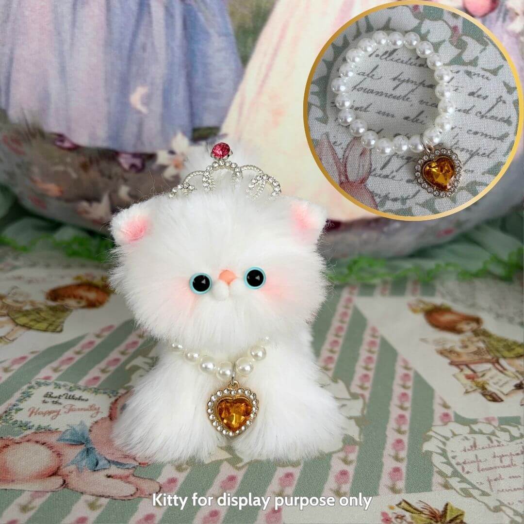 Fluffy kitten figurine wearing an Elegant Heart Necklace, featuring a heart-shaped pendant and pearl accents, perfect for display.