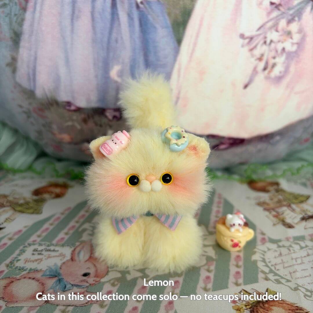 Fruity Kitten Collection: cute fluffy kitten figurine in pastel yellow with flower accessories and a bow, handmade in UK.