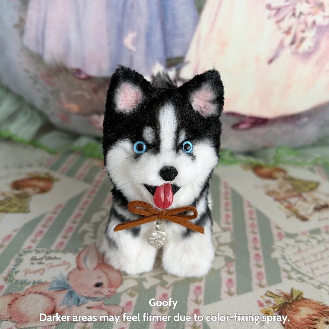 Lifelike Puppy Collection features a handcrafted black and white puppy figurine with bright blue eyes and a charming collar.