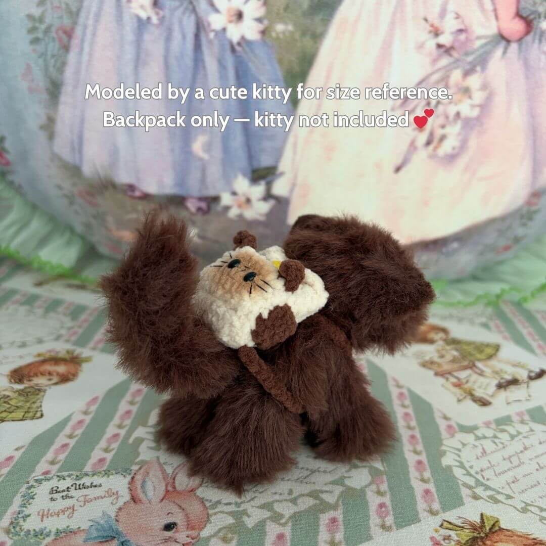 Cute fluffy kitten figurine modeling a Handmade Mini Backpack, showcasing its unique design and soft textures, perfect for collectibles.