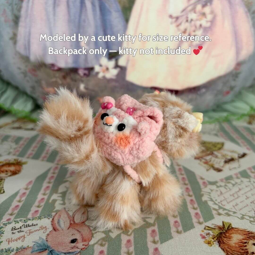 Cute fluffy miniature kitten with handmade mini backpack, featuring pink details and playful expression, perfect for collectibles.