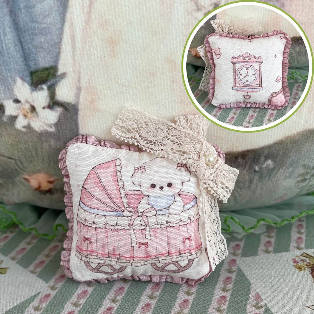 Handmade mini cuddle critter cushion featuring a cute bear in a pram, with lace bow detail, perfect for dolls or desk decoration.