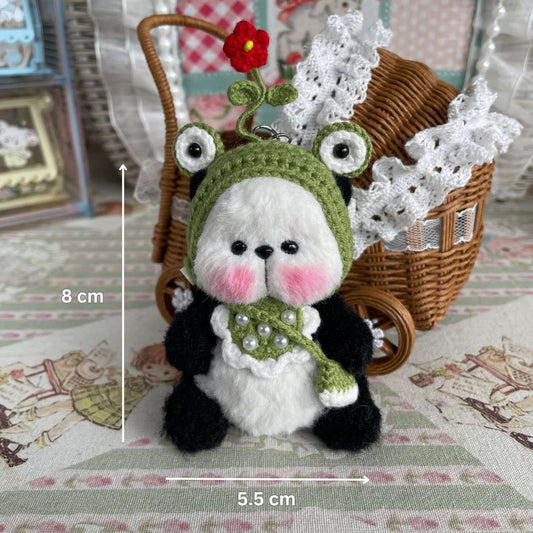 Handmade mini panda with movable joints and accessories, including apron, hat, and bag. Exquisitely crocheted by René at Kiki's Handmade Studio.