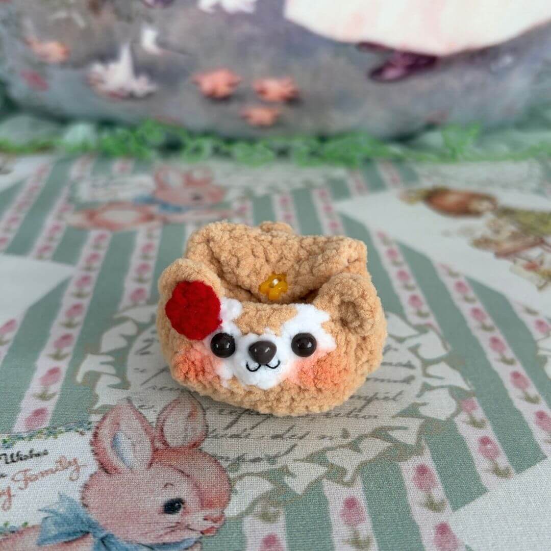Handmade Mini Backpack featuring a cute, fluffy kitten figurine with a red flower, on a soft patterned background.