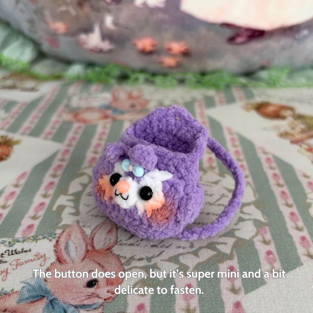 Handmade Mini Backpack in purple for miniature kittens, featuring a cute kitten face and delicate button closure, perfect collectible decor.