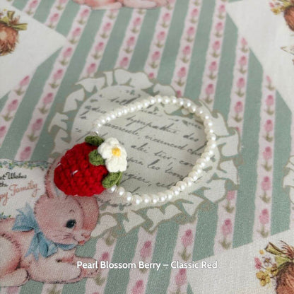 Handmade Snuggle Bits accessory featuring a cute strawberry purse with pearl beads, ideal for a fluffy kitten's fashion makeover.