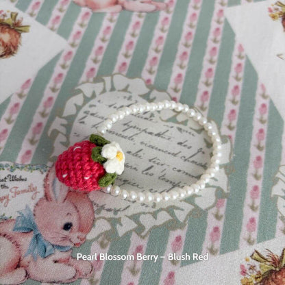 Pearl Blossom Berry in blush red with a cute handmade strawberry and white flower, perfect accessory for Snuggle Bits.
