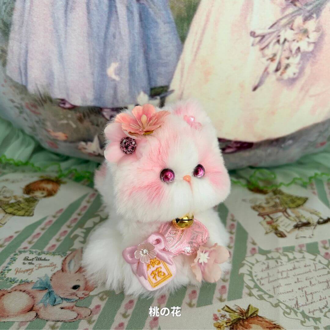 Handmade kitten from Fairy Paws Collection, fluffy white cat with pink accents, wearing flower accessories and a bell.
