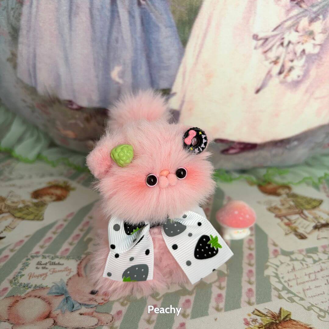 Handmade kitten from the Fruity Kitten Collection, fluffy peachy pink, with strawberry and watermelon accessories and a cute bow.
