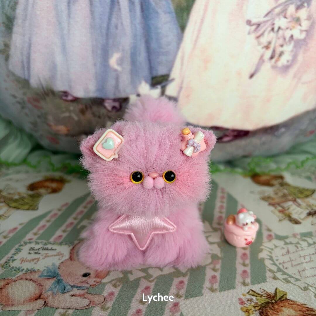 Cute pink fluffy kitten figurine from the Fruity Kitten Collection with pastel accessories and a mini dessert.