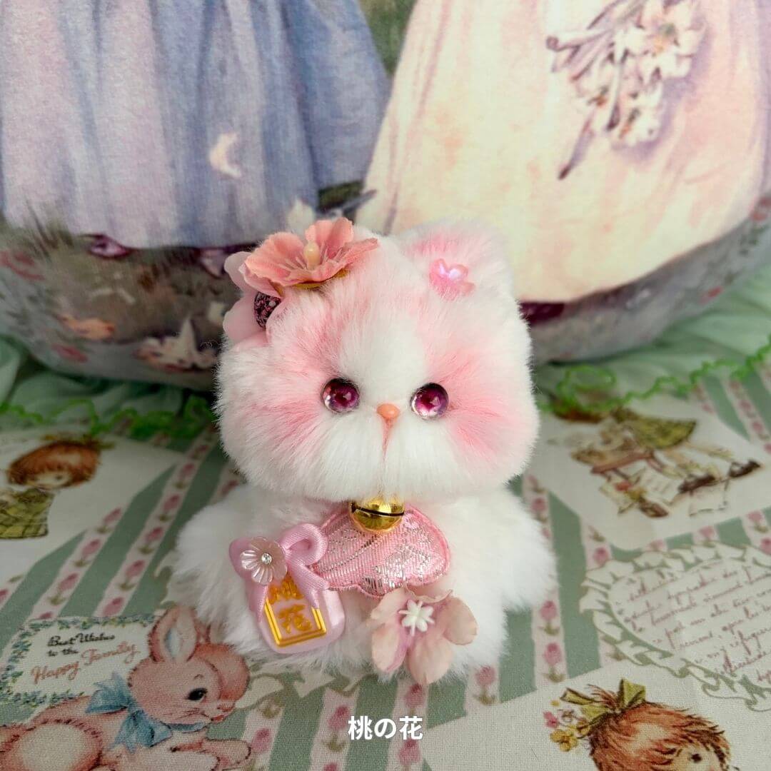 Handmade kitten from the Fairy Paws Collection with pink fur, floral accessories, a charm pouch, and pearl collar, styled as a cute collectible.
