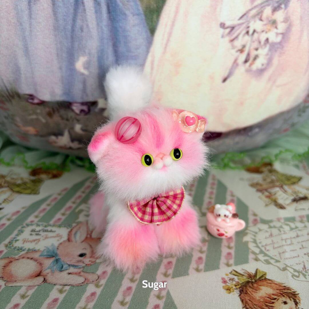 Sweet Dreams Kitten Collection: Fluffy pink handmade kitten figurine with pastel accessories and teacup charm, cute kawaii style.