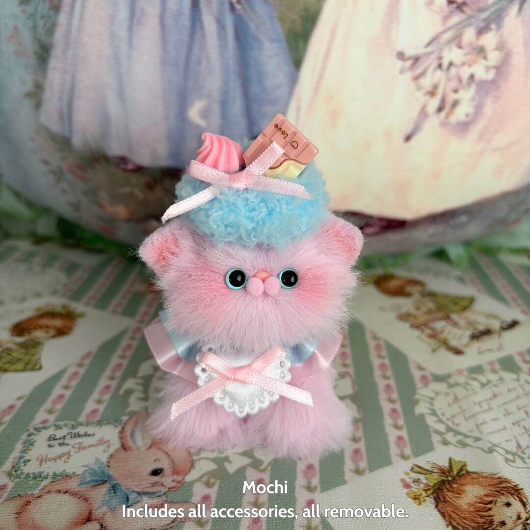 Handmade kitten named Mochi, fluffy pastel pink cat figurine with dessert hat, kawaii style, collectible Sweet Treat Kitties.