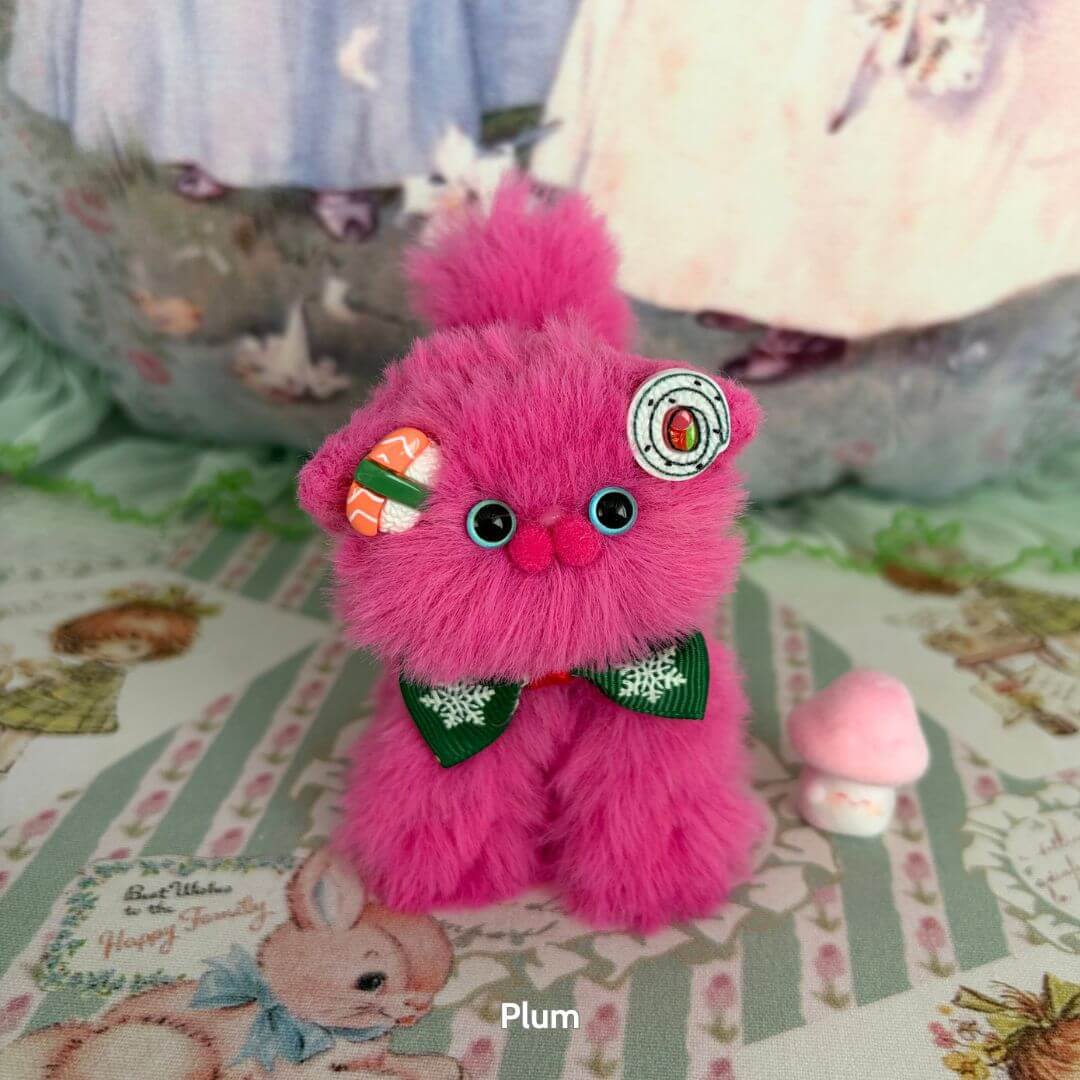 Fruity Kitten Collection featuring a fluffy pink kitten with candy decorations and a green bow, handcrafted in the UK.