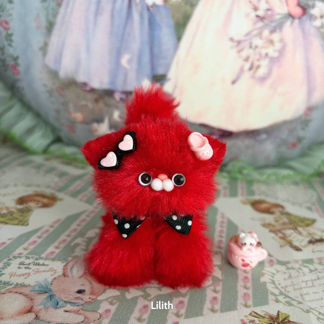 Alt Tag: Handmade kitten from the Glossy Meowgic Collection, red fluffy cat figurine with polka dot bow and heart accessories.