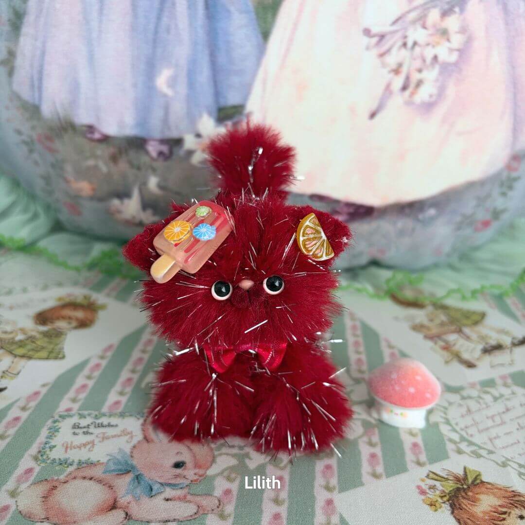 Alt Tag: Twinkling Kitten Collection, fluffy red miniature kitten with ice cream accessory, adorned with bows and sparkles.
