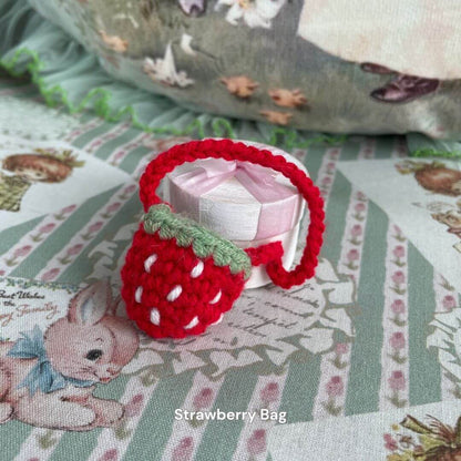 Handmade strawberry mini bag accessory for plush toys, perfect for adding charm to plush kittens or small animal decor.