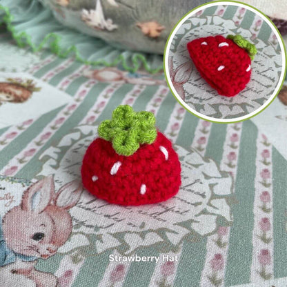 Handmade strawberry hat for plush toys, featuring a cute red crochet design perfect for dressing up your stuffed animals.