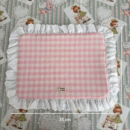 Handmade Sweet Tea Mat with pink gingham pattern and white ruffled lace trim, perfect for a cozy tea setting.