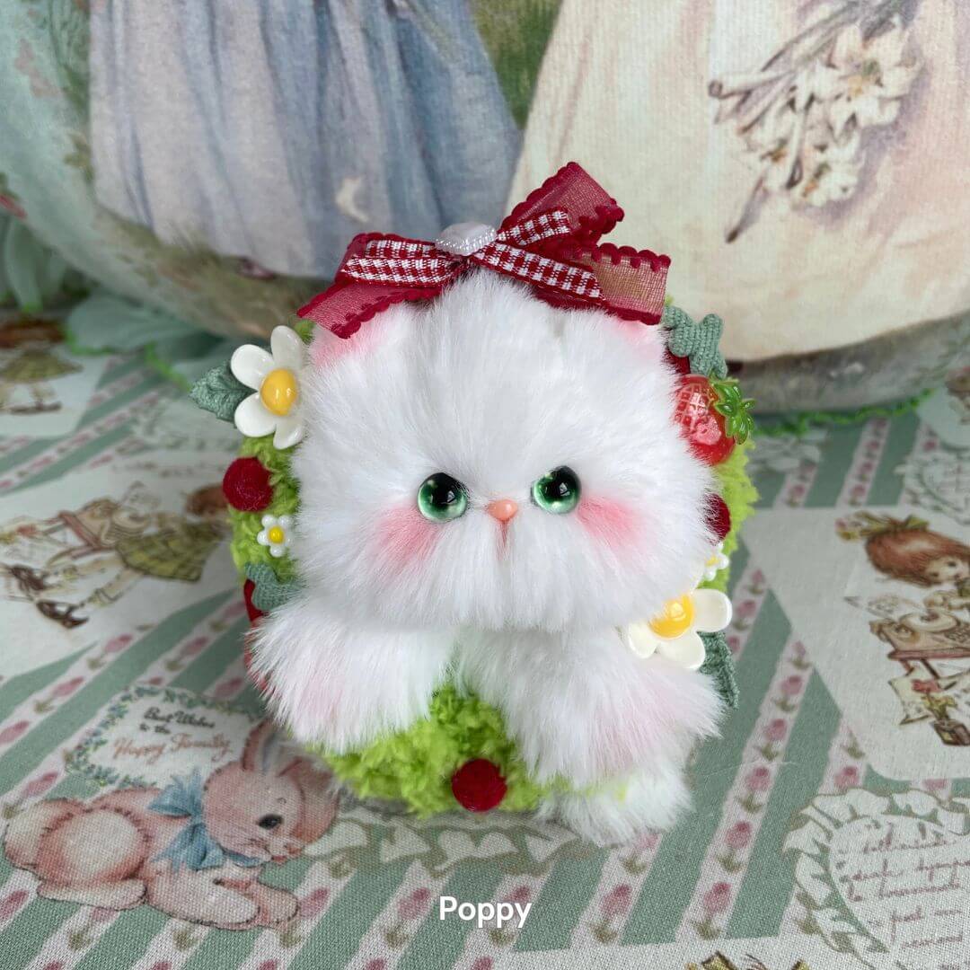 Adorable white handmade kitten from the Blossom Kitten Collection, adorned with flowers and a bow, perfect for cat lovers.