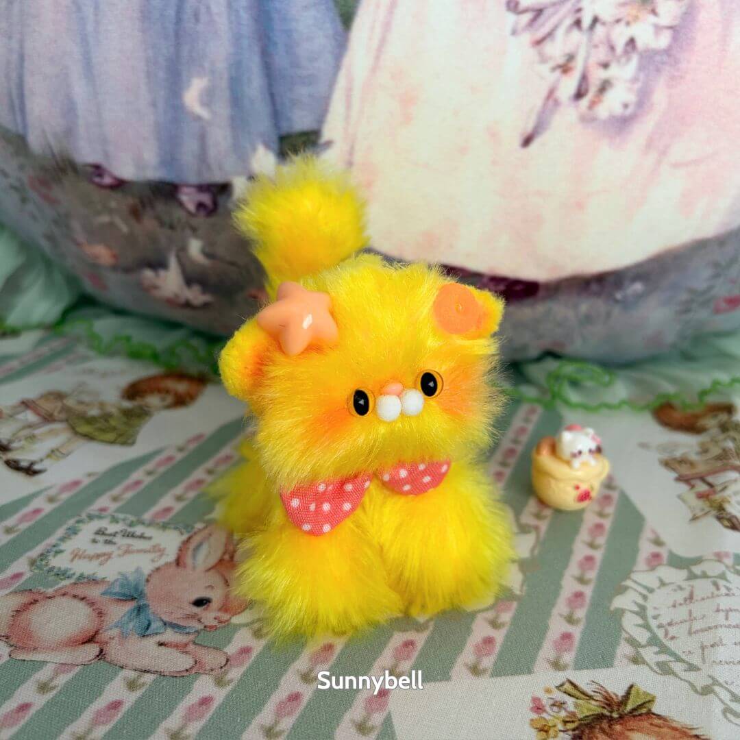 Glossy Meowgic Collection handmade kitten, fluffy yellow cat figurine with pink bow, cute animal collectible in playful pose.