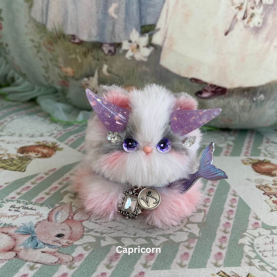 Handmade Capricorn kitten plush toy with purple horns, faux fur, and celestial accessories from the Zodiac Kitten Collection.