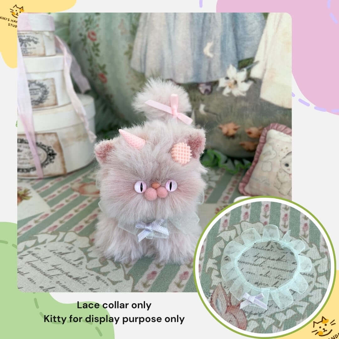 Handmade bow collar displayed on plush kitten toy, showcasing its charming and adorable design.