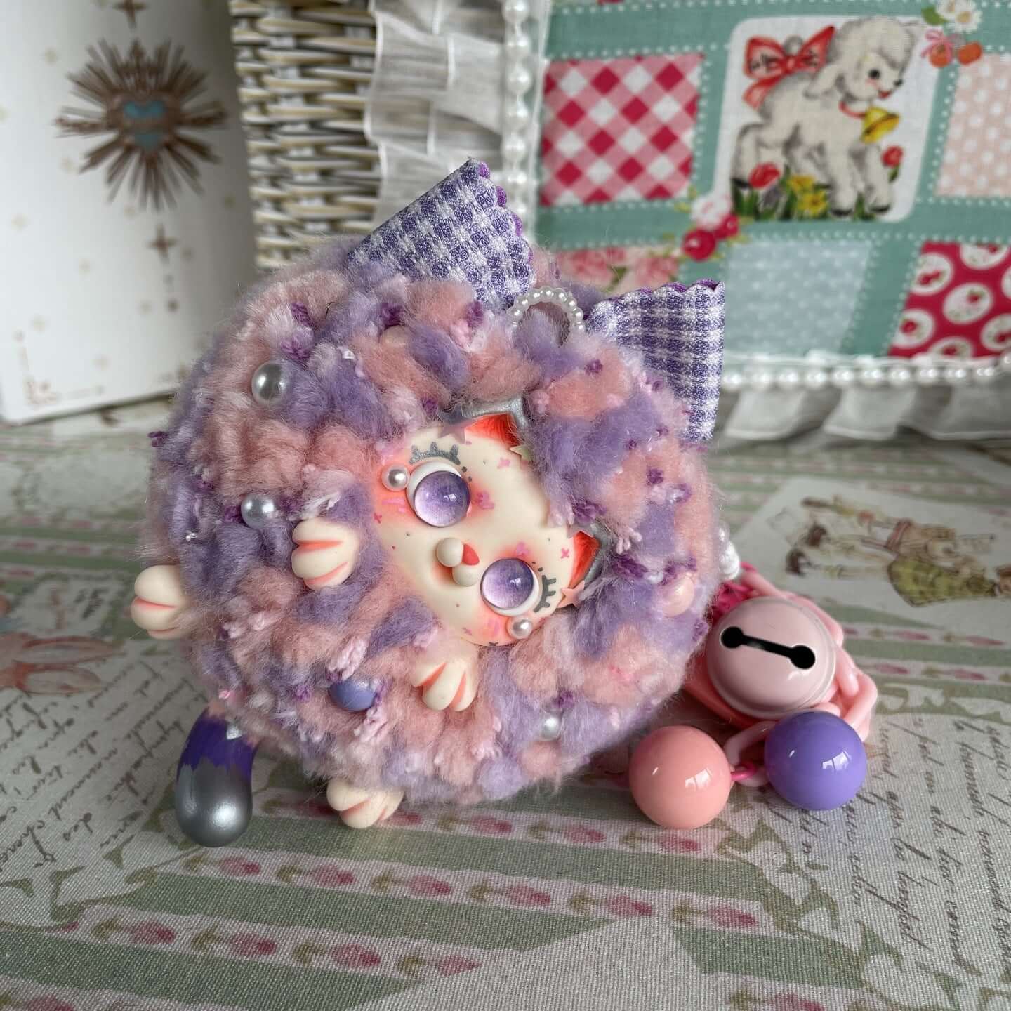 Fluffy Kitten Ball Bag Pendant in pastel colors with cute details, displayed on a decorative surface; Limited Edition.