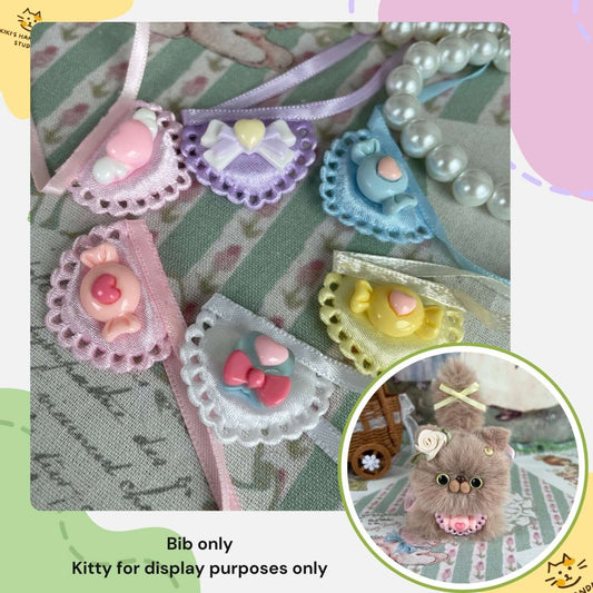 Set of handmade mini bibs with colorful bows for kitten plush toys, featuring a decorative display plush kitten. Bib only, kitten for display.