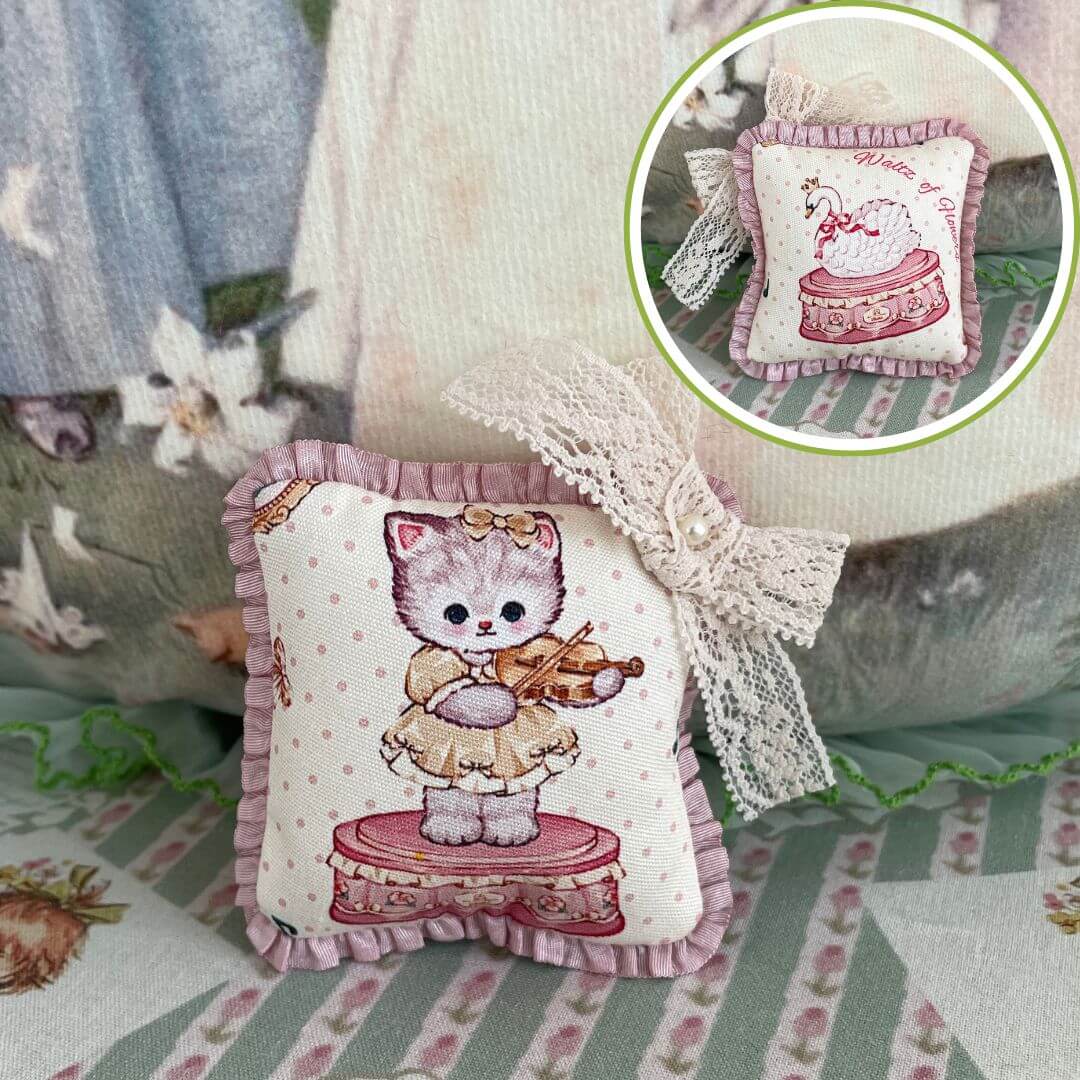 Handmade mini cuddle critter cushion featuring a cute kitten design with a hand-stitched bow, perfect for decoration or dolls.