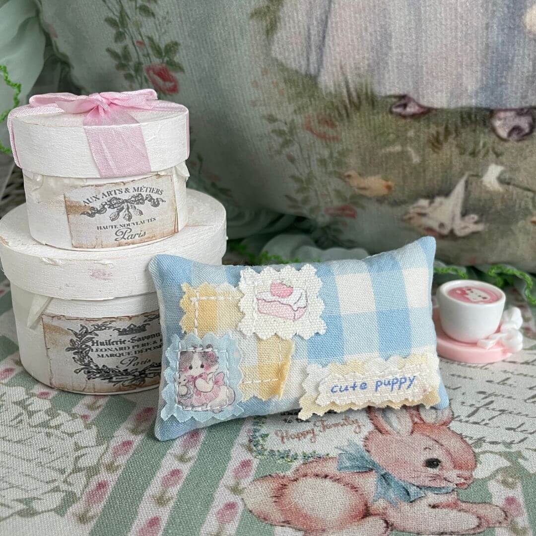 Handmade mini pillow with blue plaid design, cute puppy motif, and decorative packaging, perfect for doll or plush toy settings.