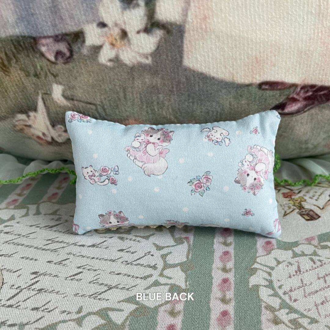 Handmade mini pillow with kitten print on blue fabric, perfect for decorating dollhouse or tiny animal home.