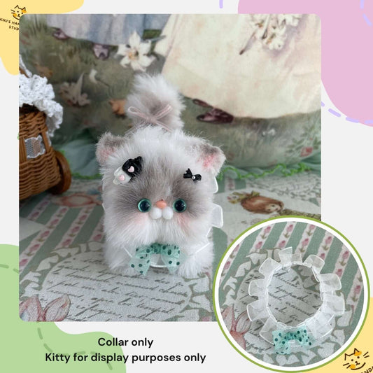 Handmade polka dot bow collar on plush toy kitten for decoration display.