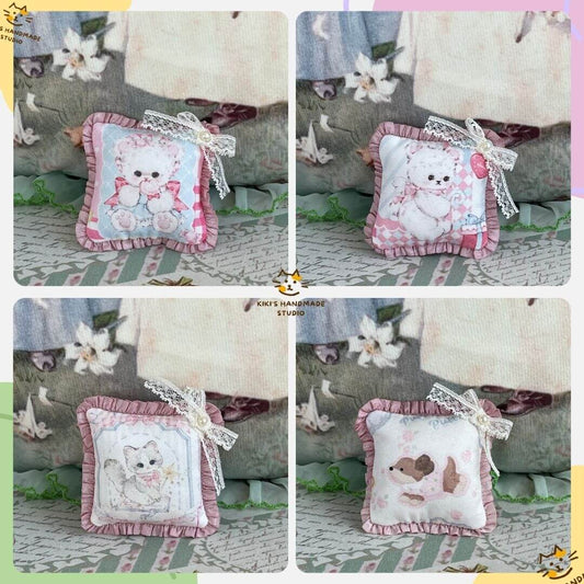Handmade tiny cuddle critter cushions with hand-stitched bow, featuring kitten and puppy designs; perfect plush toys or decor gifts.