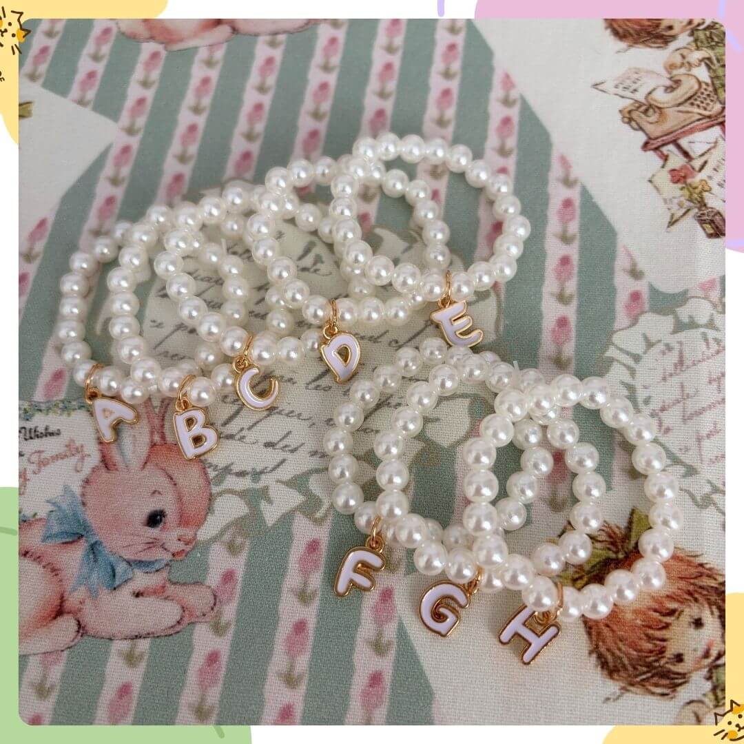 Initial Pearl Necklace with faux pearls and gold letter charms, perfect for personalizing your style.