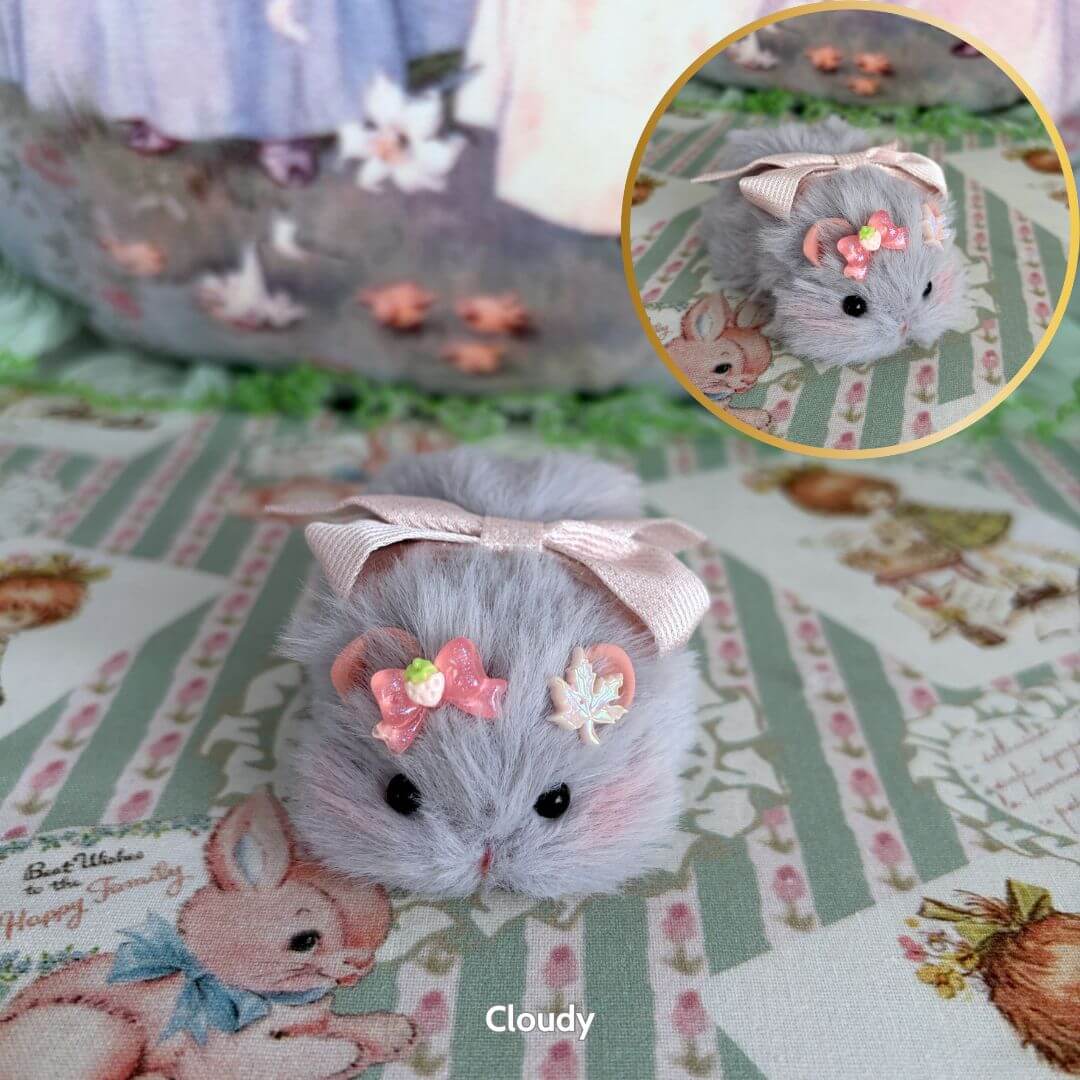 Lying Hamsters Figurines in soft gray fur, adorned with floral accessories, cutely posed for a charming collectible decor.
