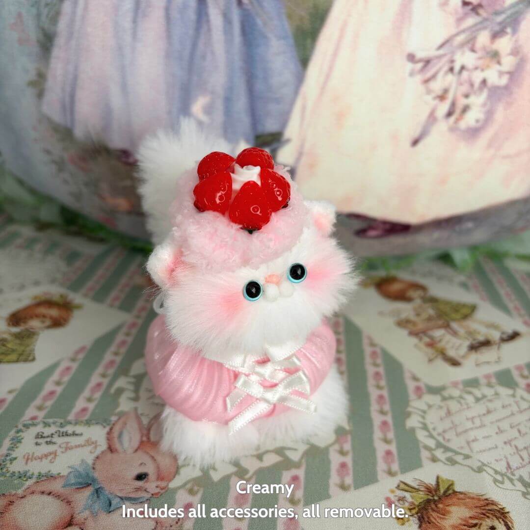 Sweet Treat Kitties handmade kitten, fluffy cat figurine with pink fur and strawberry accessory, designed as cute animal collectible.