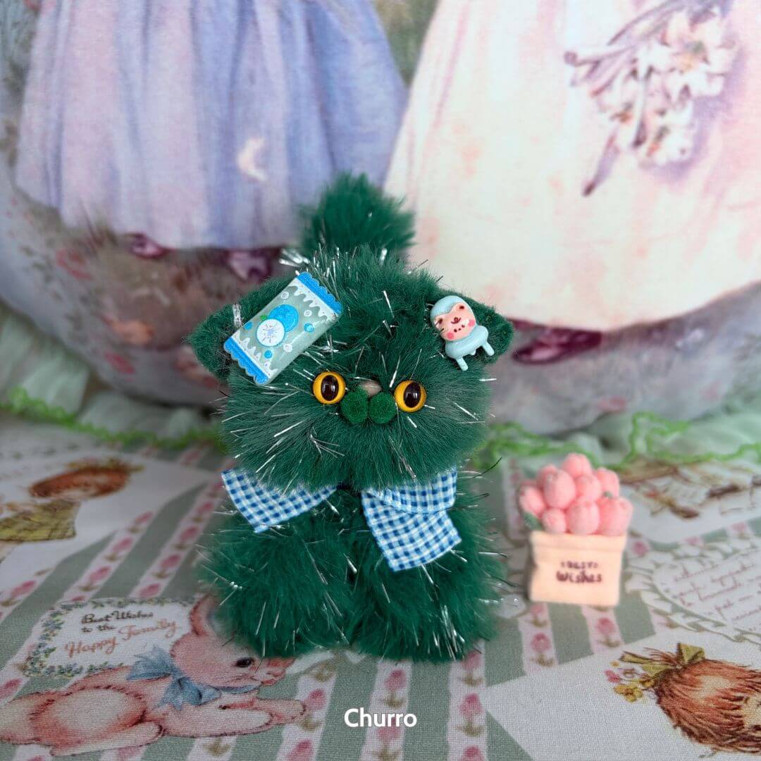 Alt Tag: Twinkling Kitten Collection green fluffy kitten figurine with blue bow and accessories, cute animal collectible.