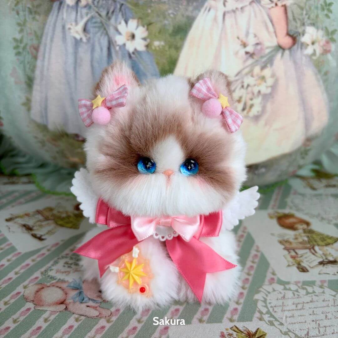 Enchanted Big Paws Collection fluffy kitten figurine with blue eyes, pink bows, and a cute dress, handmade in UK.