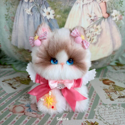 Enchanted Big Paws Collection fluffy kitten figurine with blue eyes, pink bows, and a cute dress, handmade in UK.