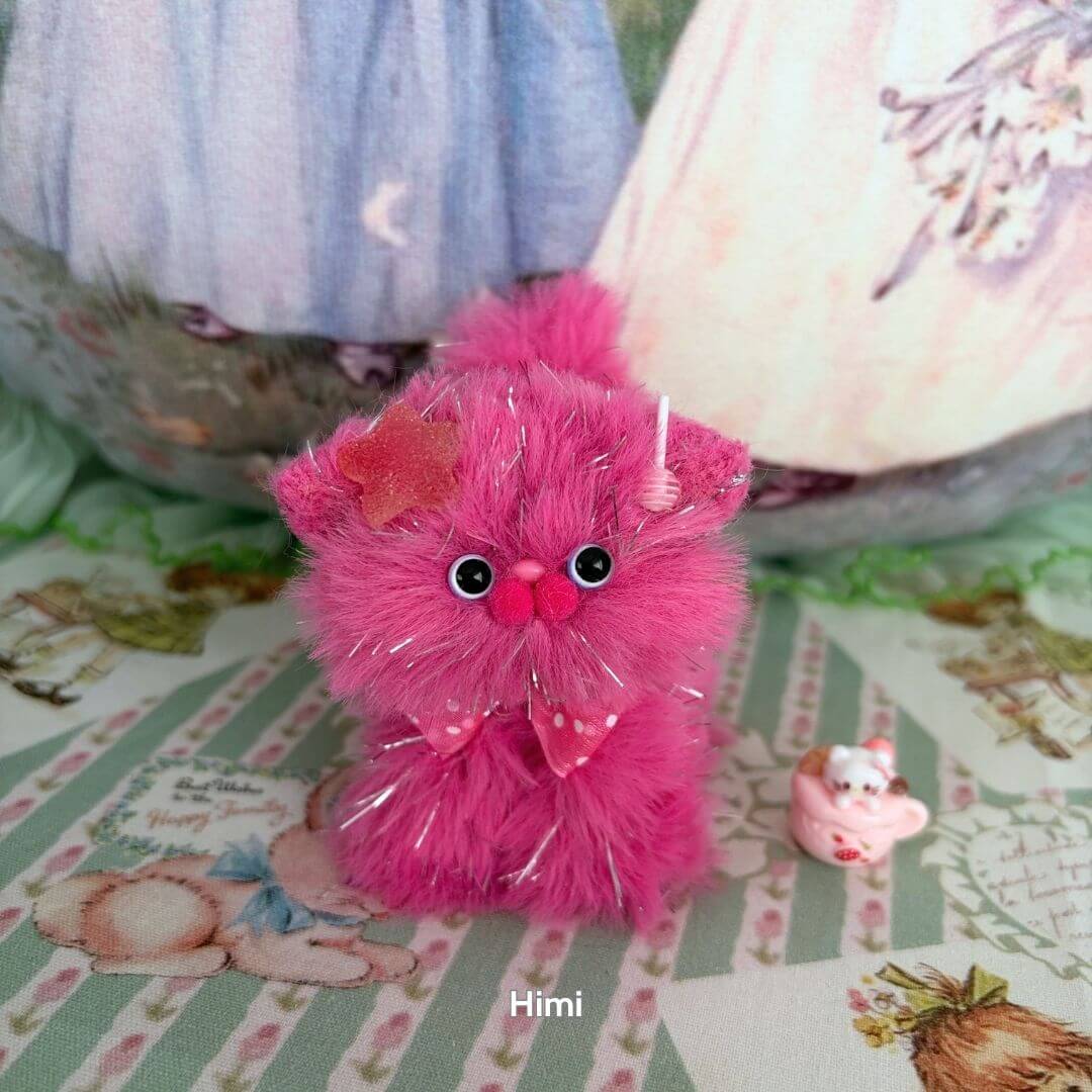 Twinkling Kitten Collection: Fluffy pink kawaii cat figurine with star accents and a playful bow, handmade in the UK.