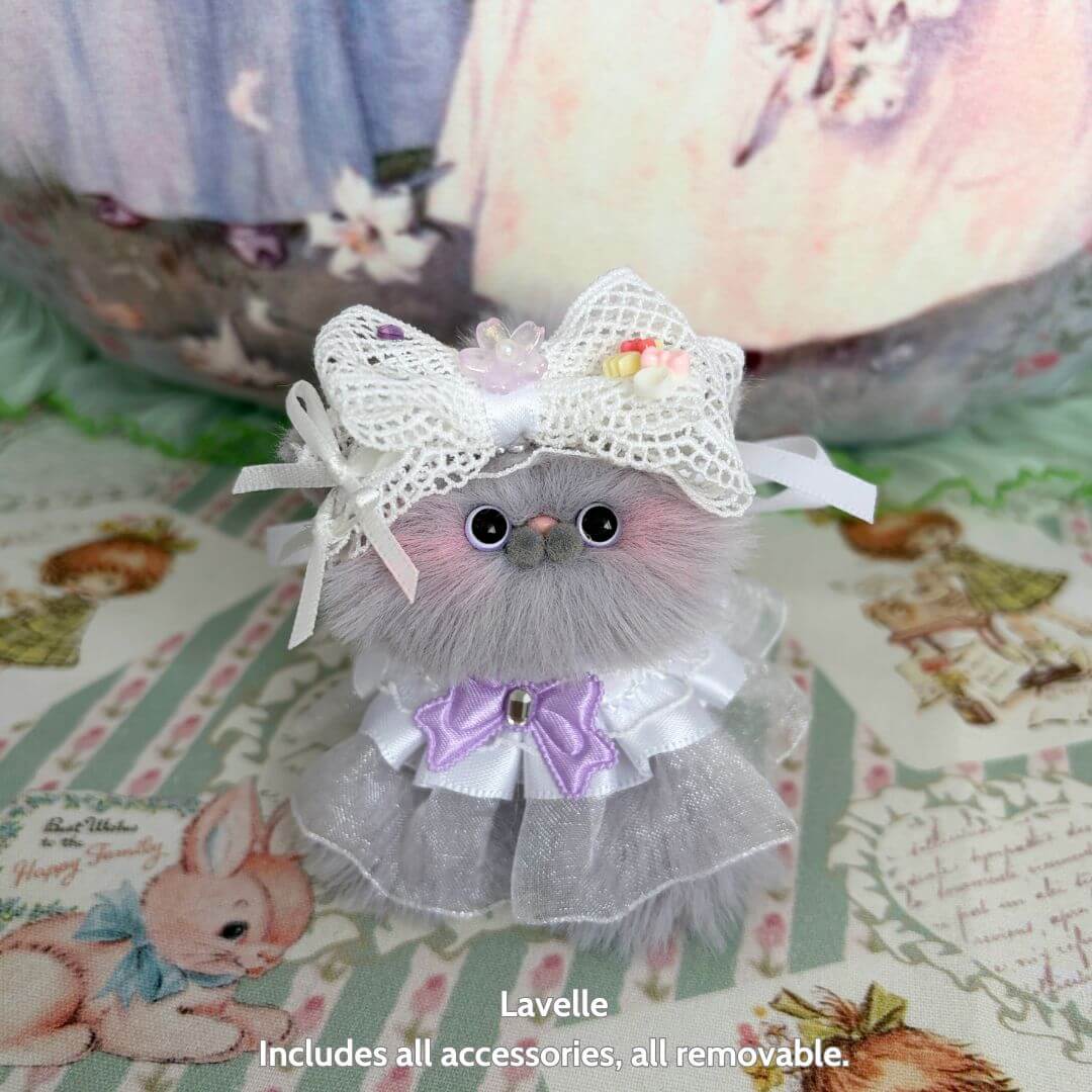 Handmade kitten from the Petals & Whispers Collection, featuring fluffy gray fur, a floral bow, and a cute tulle dress.