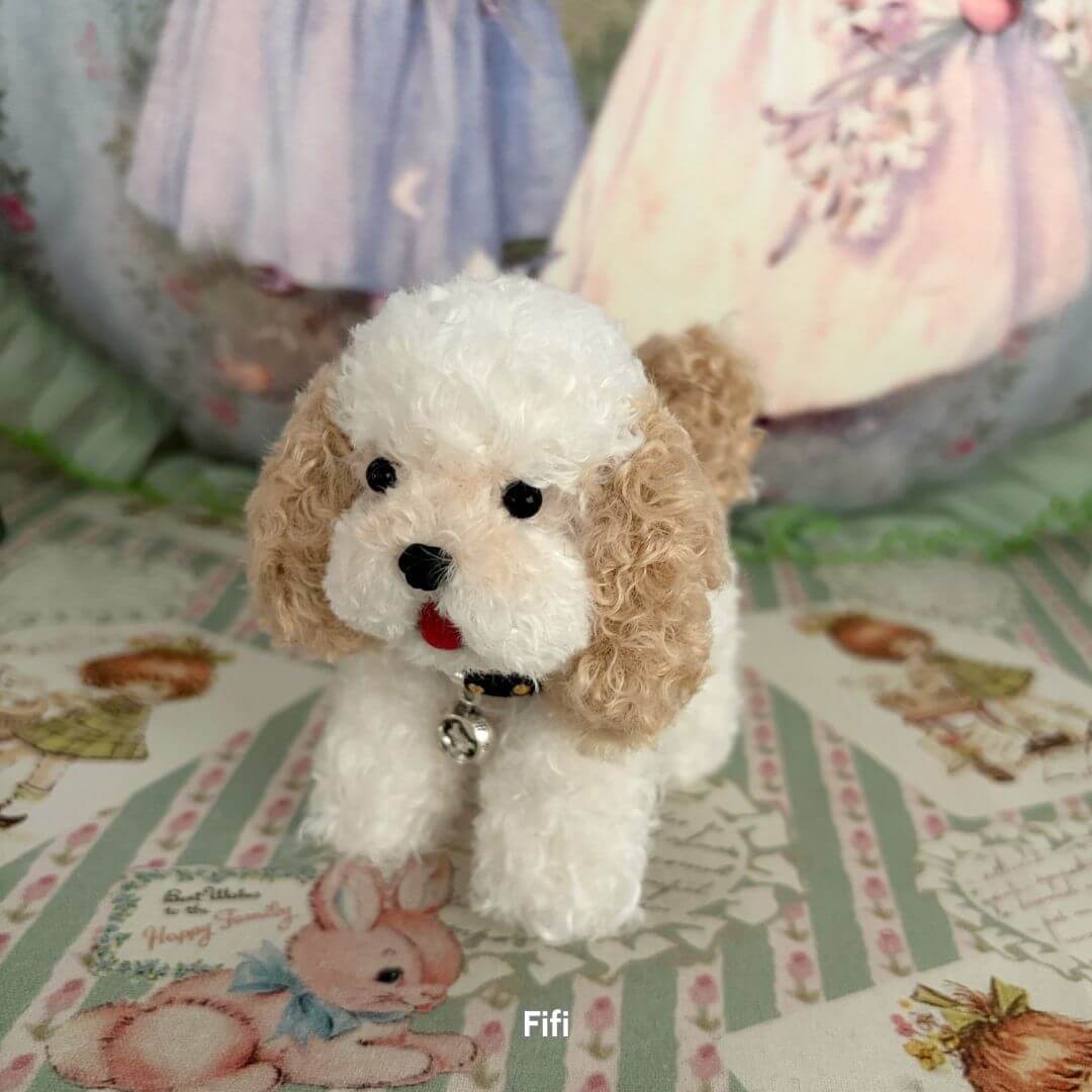 Lifelike Puppy Collection showing a fluffy white and tan handmade puppy figurine with expressive features, styled in a cute pose.